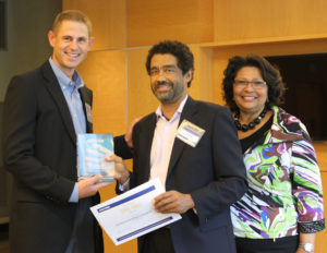 CEO, Walter Allen, receiving a 2015 DBE DBE Award ("Diverse Business Enterprise: Delivering Business Excellence") from Jacobs at their 2015 DBE Networking Event on September 24th. Pictured left to right are Tyler Sheldon (Jacobs), Walter Allen, and Gabriele Mack (Jacobs).