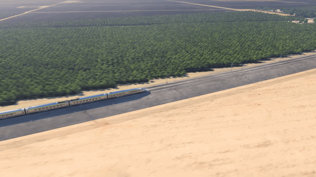 A high-speed rail train travels across a valley landscape